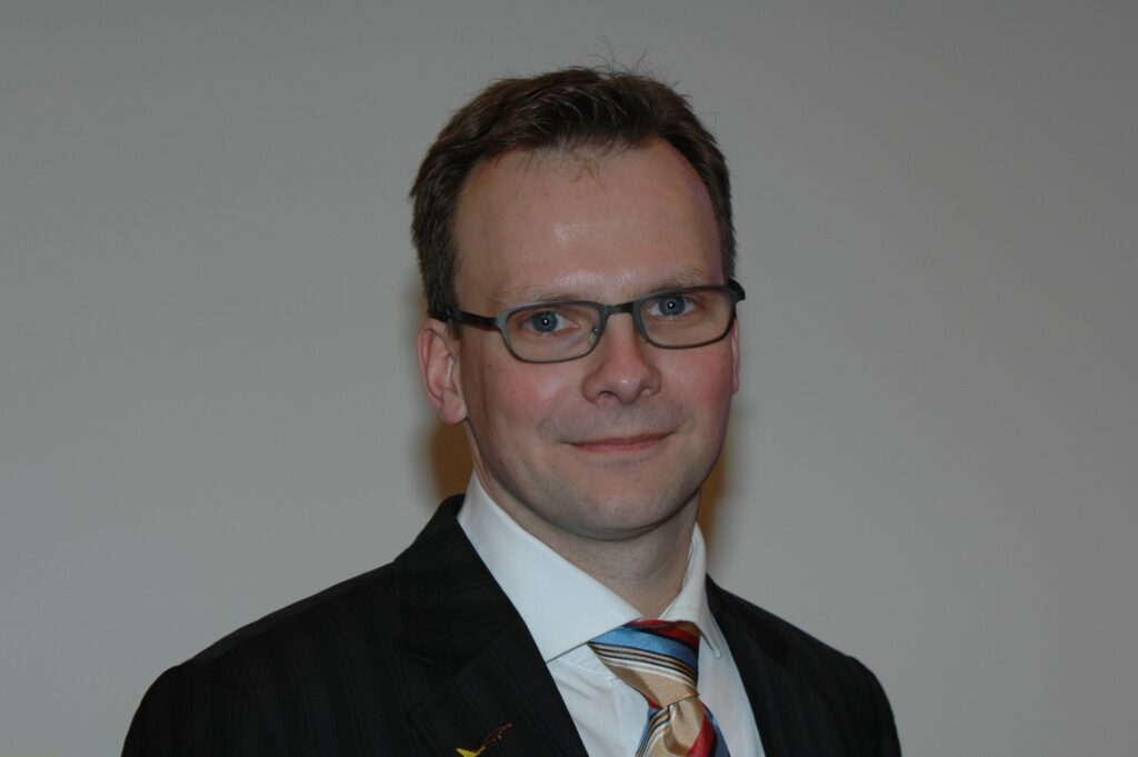 Andreas Bierwirth Andreas Bierwirth mit dunklem Anzug und Brille lächelt in die Kamera