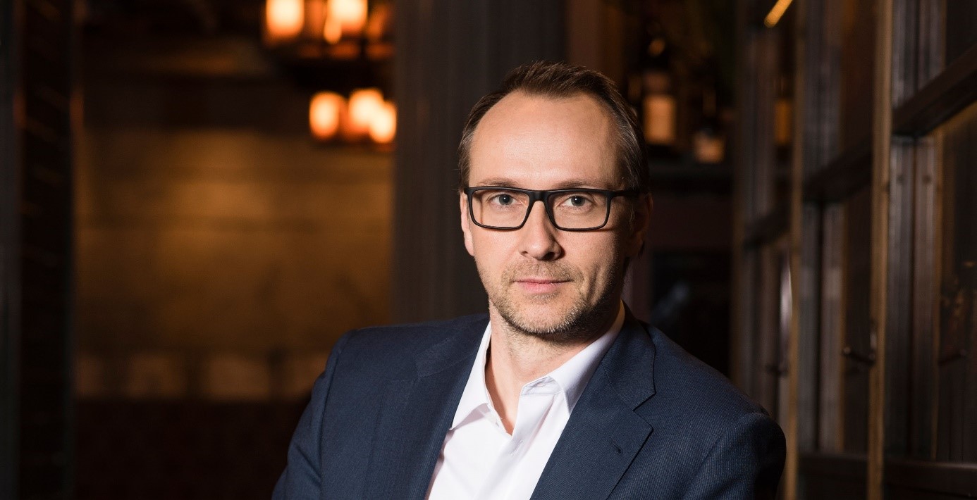 Mann mit Brille blickt in die Kamera